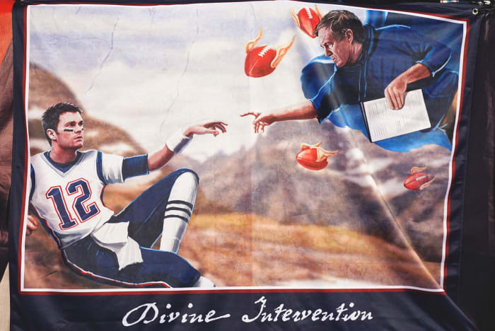 A banner depicting Tom Brady and Bill Belichick in Michelangelo’s painting, ‘Creation of Adam from the Sistine Chapel.’